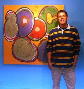 Joel Reid with a painting from his 'Robots in Disguise' exhibit at the Courthouse Art Gallery. Last weekend to catch it!