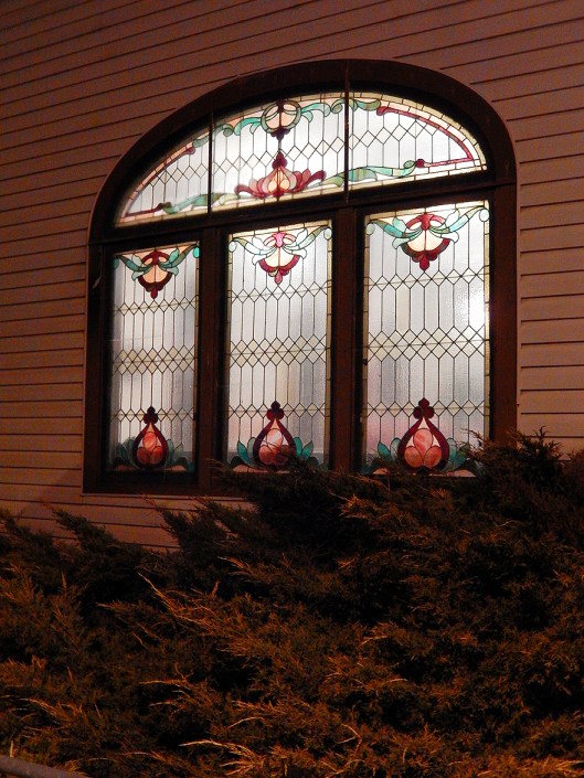 With Christmas preparations, the beautiful stained glass windows of Trinity United Church are more often alit.